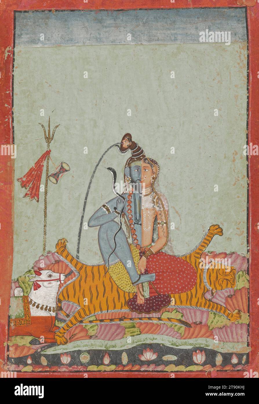 Shiva Ardhanarisvara, c. 1700-1750, 8 1/8 × 5 5/8 in. (20.64 × 14.29 cm) (image)25 3/4 × 21 3/4 × 1 in. (65.41 × 55.25 × 2.54 cm) (outer frame), Opaque watercolor heightened with gold on paper, India, 18th century, In this hypnotic image, the Hindu god Shiva and his wife Parvati share one body, in the form known as Ardhanarisvara, ‘lord whose half is woman.’ It reveals Shiva as a symbol of his omnipotence, the seed and womb of all creation and destruction. Here, a razor-sharp vertical divides and unites the image, with the artist depicting the respective halves Stock Photo