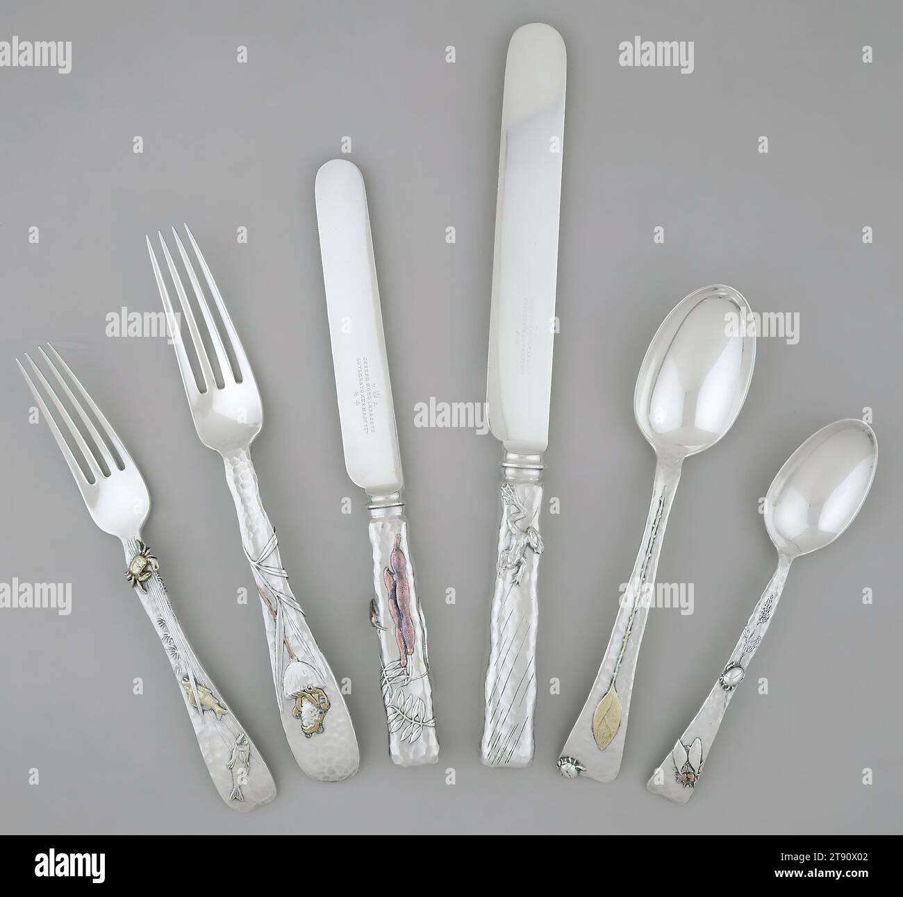 Lap-Over-Edge' Flatware, 1880, Charles T. Grosjean; Maker: Tiffany & Co.; Caster: Joseph Rodgers and Sons (knife blades), American, 1/2 x 11 1/2 x 7/8 in. (1.27 x 29.21 x 2.22 cm), Silver, gold, copper, and bronze, United States, 19th century, This opulently naturalistic flatware incorporates Japanese motifs such as plants, flowers, insects, and animals. Edward C. Moore, Tiffany's head designer from 1869-1891, had admired Japanese art and design at the 1867 Exposition Universelle in Paris, and began working with his designer Grosjean to incorporate Japanese motifs into Tiffany's projects Stock Photo