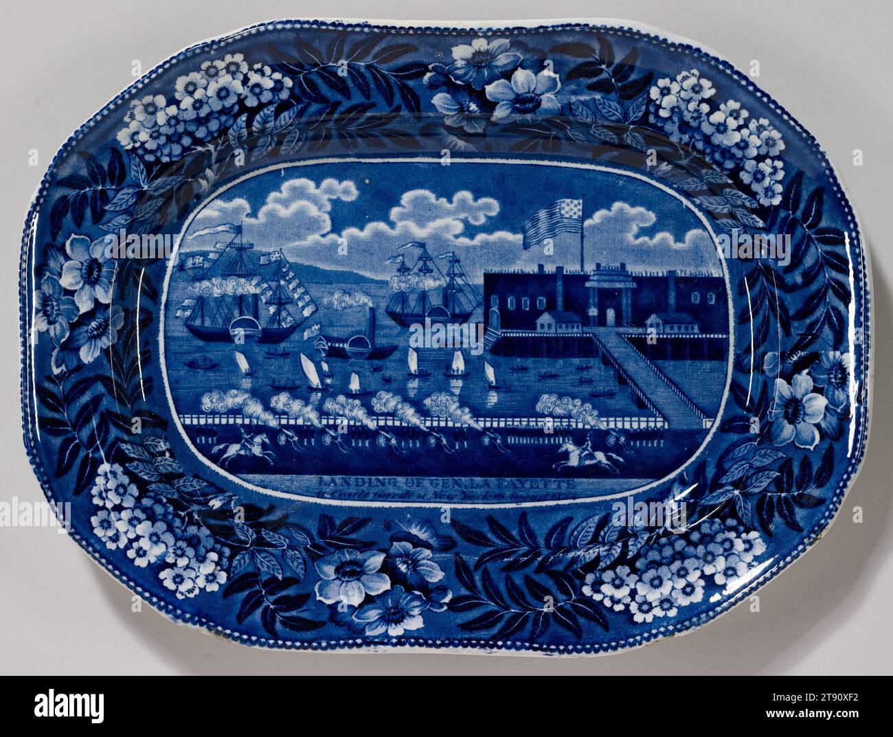 Platter, c. 1825, James & Ralph Clews, English, Cobridge, Staffordshire, England, 1818 - 1834, 1 1/4 x 12 x 9in. (3.2 x 30.5 x 22.9cm), Porcelain, England, 19th century, This platter commemorates Revolutionary War hero General Lafayette's landing in New York for his famous tour in 1824. It illustrates how Staffordshire potteries developed industrial production techniques, such as transfer-printing, which consisted of printing decoration onto tissue which was affixed to the ceramic body before firing; the paper burns away in the kiln while the ink remains. This allowed to increase production Stock Photo