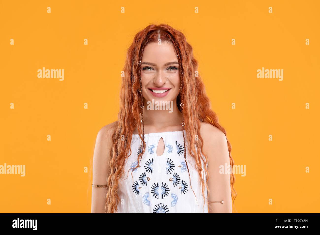 Beautiful young hippie woman on orange background Stock Photo
