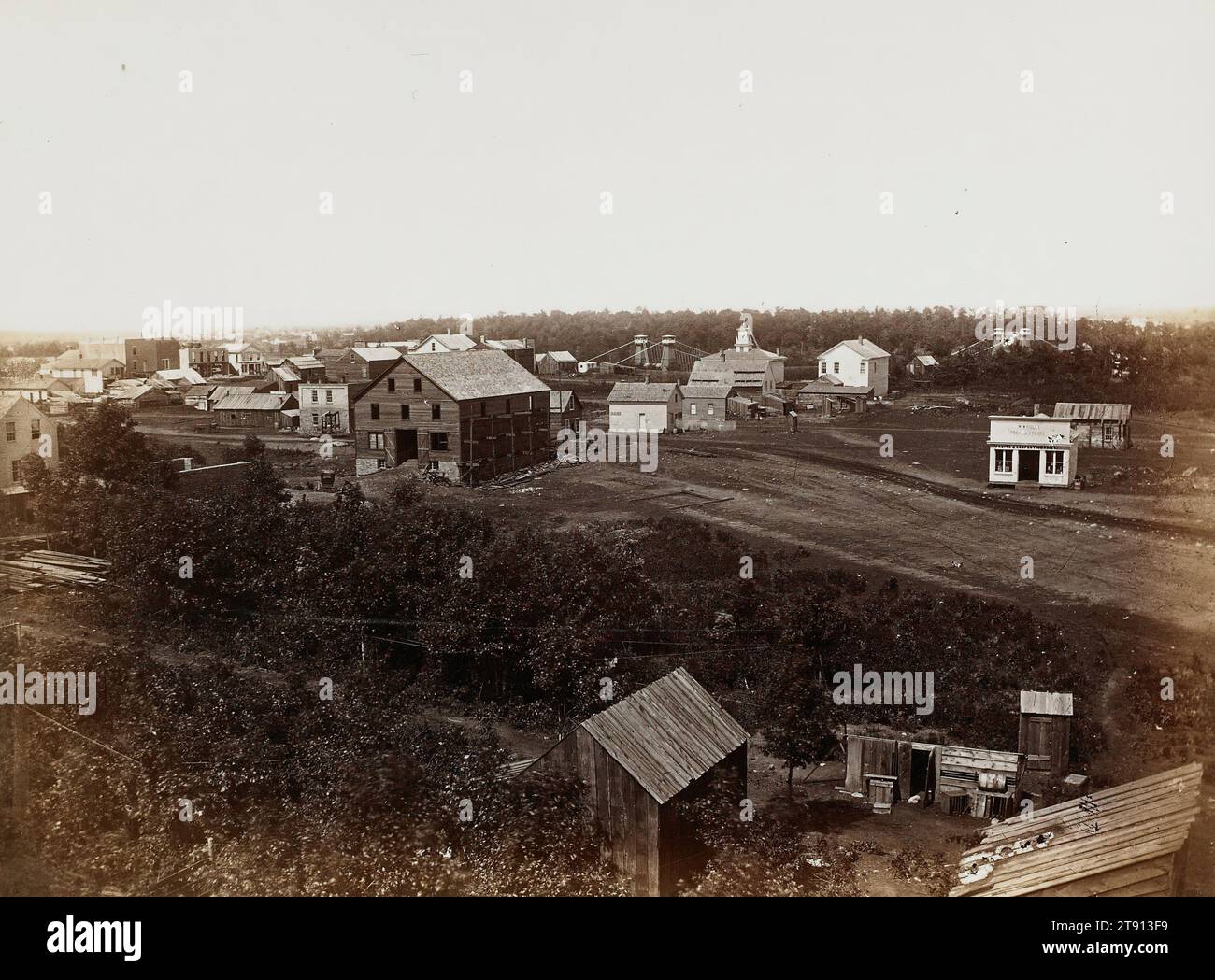 Minneapolis, from Second Avenue South toward Suspension Bridge, 1857, Benjamin Franklin Upton; Publisher: Edward A. Bromley, American, born 1818, 6 1/16 x 8 3/16 in. (15.4 x 20.8 cm) (image)10 x 11 7/8 in. (25.4 x 30.16 cm) (mount), Albumen print (printed c.1870), United States, 19th century Stock Photo