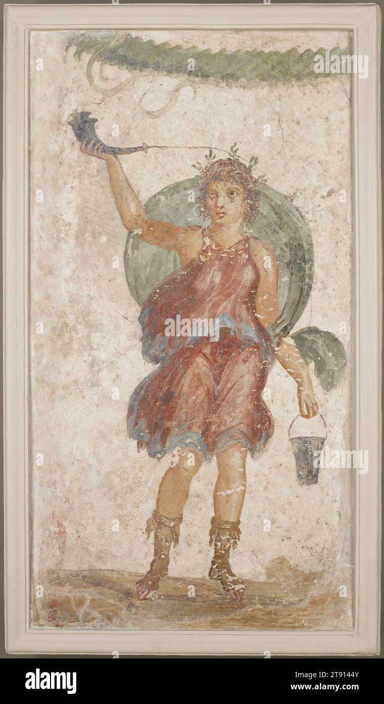 Standing Deity Holding Horn and Bucket, 1st century, 33 3/4 x 18 1/2 in. (85.73 x 46.99 cm), Fresco, Italy, 1st century, This panel comes from Pompeii, a prosperous city in southern Italy destroyed by the eruption of Mount Vesuvius in A.D. 79 and only rediscovered in 1748. It is a fragment of a larger wall painting removed during a 19th-century excavation. The figure probably represents a Lar, a Roman ancestral god honored as a guardian of the family’s welfare, and worshiped in a household shrine called a lararium. The god carries a drinking horn and a wine bucket, and wears a short Stock Photo