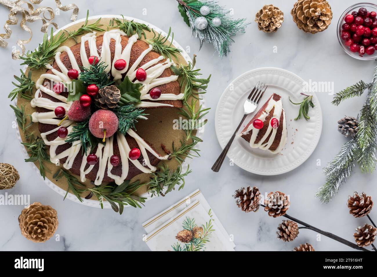 A decorated chocolate bundt cake with buttercream frosting and one