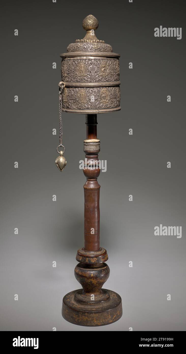 Prayer Wheel, 18th-19th century, 25 x 5 1/4 in. (63.5 x 13.34 cm) (overall), Silver, wood, and paper, Tibet, 18th-19th century, In Tibetan Buddhism, prayer wheels are akin to rosaries, imbued with a powerful belief in the meditative repetition of sacred syllables, sounds, and prayers. A prayer surrounds the silver cylinder, while inside is a long, tightly rolled paper scroll printed with prayers and invocations. As the wheel spins with the aid of a suspended weight, the printed prayers are 'sent out' with each revolution. The wheel’s rotation equates to the reading or reciting Stock Photo