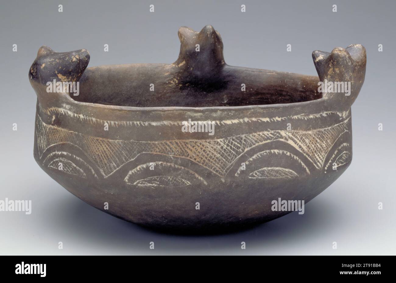 Bowl, 1250-1499, 4 x 9 1/2 in. (10.16 x 24.13 cm), Ceramic, United States, 13th-15th century, Bears have long been seen among many Native cultures as beings with unusual powers. They reappear each spring after a long hibernation, so are associated with renewal and healing. Their strength and ferocity, combined with their many physical similarities to humans, made them frequently emulated by hunters and warriors. Bears often served as clan animals linking an entire extended family group. The ones depicted on this bowl could have been meant to evoke any of these meanings Stock Photo