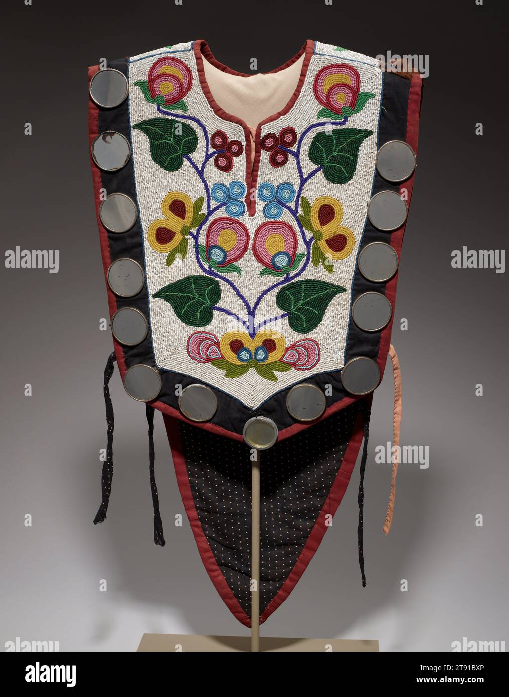 Cape, 19th-20th century, 29 x 15 3/4 in. (73.7 x 40.0 cm), Cotton, glass beads, fur, metal, mirrors, United States, 19th-20th century, This spectacularly decorated man's cape would have have been part of an ensemble of beaded clothing, made by an Anishinabe woman for a male relative to wear on special occasions such as social and religious events. Anishinabe women were known for their skill at beadwork and textile ornamentation. The floral designs here are typical of their work, while the mirrors add an extra element of shine and color. The rich and extensive decoration added to the value Stock Photo