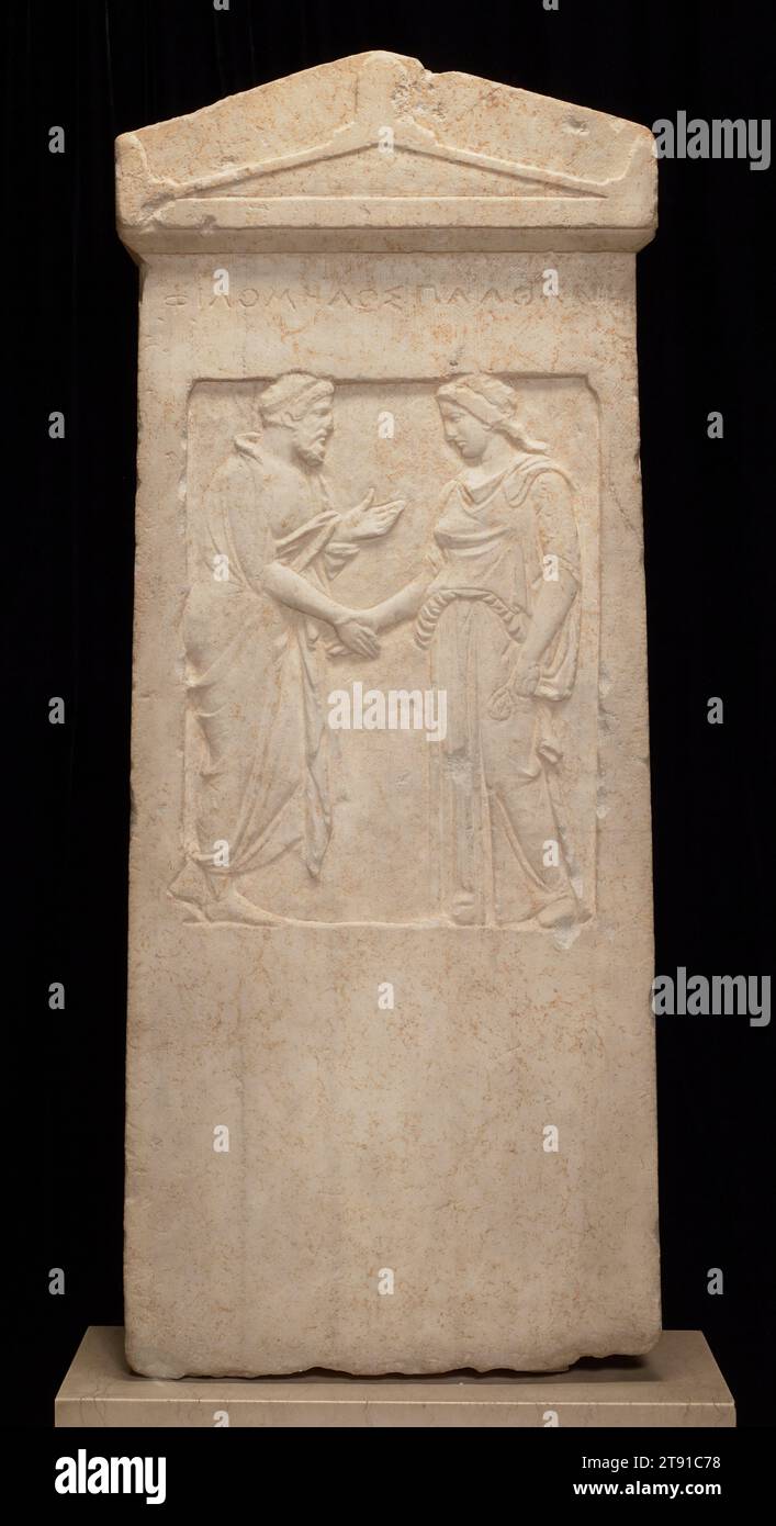 Grave Stele, 5th century BCE, 33 3/4 x 13 5/8 x 4 7/8 in. (85.73 x 34.61 x 12.38 cm), Pentellic marble, Greece, 5th century BCE, This gravestone, or stele, came from a street of tombs known as the Kerameikos, which lies immediately outside the walls of Athens. The inscription identifies the man as Philomelos and the woman as Plathane. Unlike the funereal art of many other civilizations, Greek monuments emphasized life rather than death—the memory of the dead in the minds of the living. Carved in low relief, the couple is shown either in the act of departing from one another in this world Stock Photo
