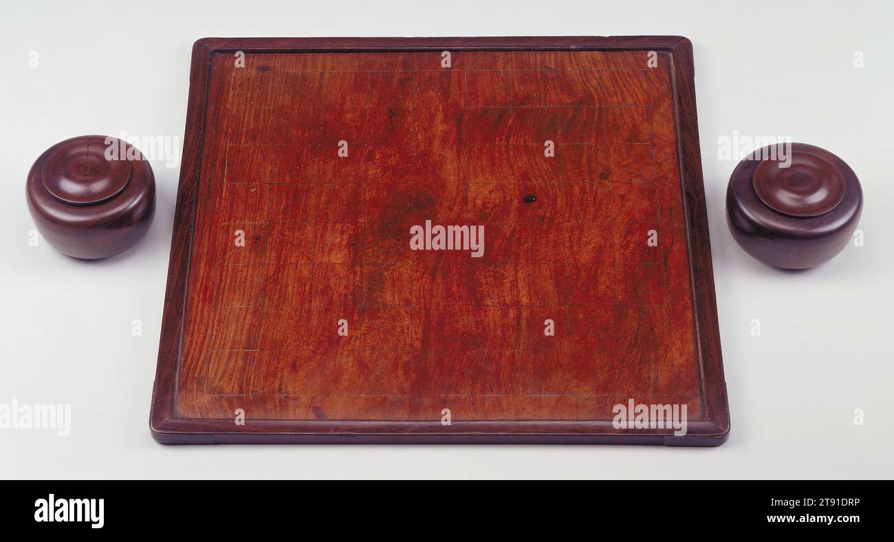 Game Board, 17th century, 9 1/16 x 19 x 19 in. (23.02 x 48.26 x 48.26 cm), Huang-hua-li, ji-chi-mu hardwood, zitan and brass, China, 17th century, The Chinese have played weiqi, or go, since ancient times and it is first mentioned in the Confucian classics of the fifth century B.C. Both men and women of the educated class played weiqi and to the literati, it became a symbol of the intellect. This huanghuali board is framed in jichimu hardwood and inlaid with silver. One side is a board for weiqi, while the reverse is a board for chess, or xiangqi or elephant chess. Stock Photo