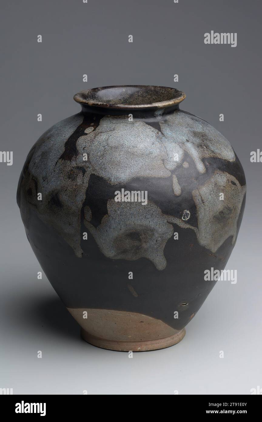 Jar, 8th century, 9 3/8 x 8 1/4 in. (23.81 x 20.96 cm), Huangtao ware Stoneware with splashed phosphatic markings against a dark brown glaze, China, 8th century, The most prominent high-fired Tang ceramics produced in northern China were black wares from the Huang tao kiln, Jia county, in Hunan province. Many pieces made there during the eighth and ninth centuries feature blue, grey, amber, or white phosphatic splashes against rich black grounds. With thick glazes that run, drip and pool together in seemingly random ways, these vessels have freer, more casual appearances Stock Photo