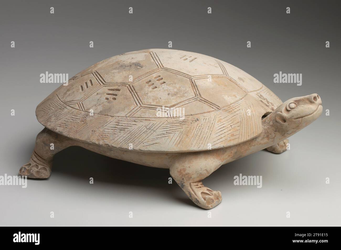 Ink tablet in the form of a turtle, 1st century, 10 x 4 x 4 in. (25.4 x 10.16 x 10.16 cm), Earthenware with modeled and incised decor including the Eight Trigrams of the I-Ching (The Book of Changes), China, 1st century, This charming Han dynasty (206 BCE - 220 CE) ink stone, modeled in the form of a turtle, features 'the eight trigrams' ba gua carved into the top of its removable shell. The eight trigrams are among the earliest and best-known images associated with Daoism. These visual symbols are the basis for the sixty-four hexagrams of the ancient divination text, the I-Qing Stock Photo
