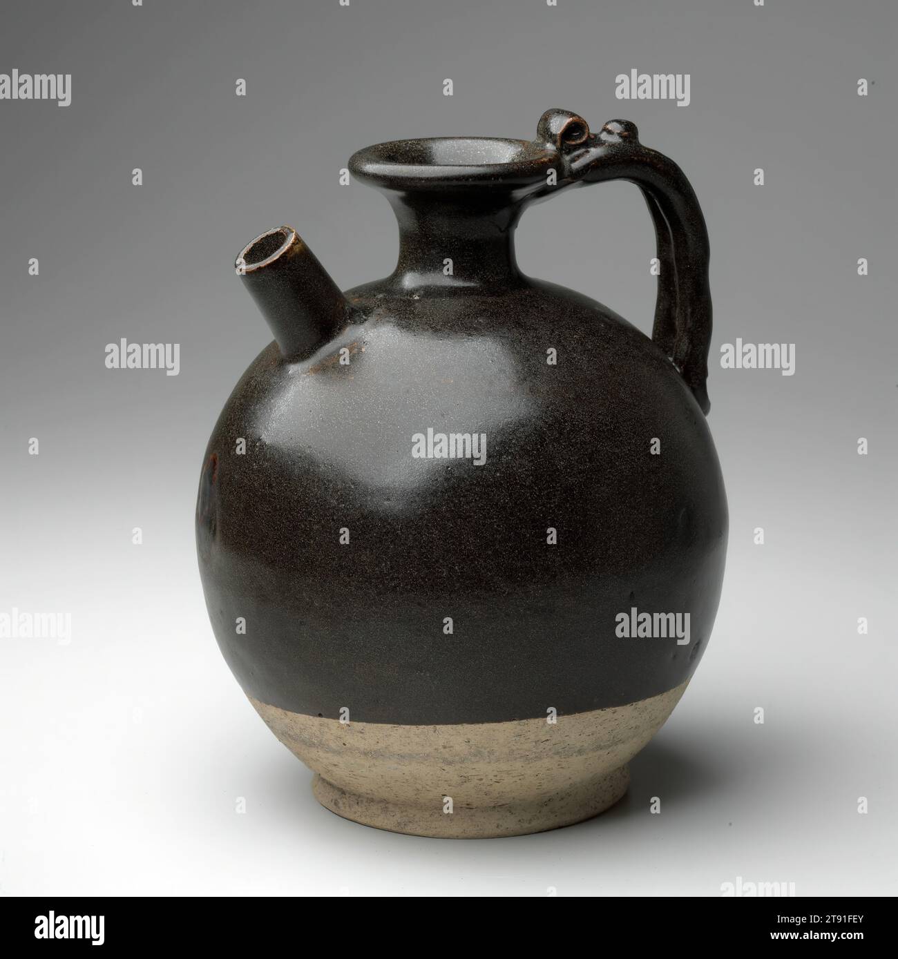 Ewer, 8th-9th century, 9-1/4 x 7-1/2 x 7-1/2 in. (23.5 x 19.1 x 19.1 cm), Huangpu ware Stoneware with dark-brown glaze, China, 8th-9th century, This well-proportioned, globular shaped ewer stands on a solid foot. It has a short, straight spout and a handle of joined double strands that arcs between shoulder and lip. The overall effect is pleasing: a simple robust shape combined with a thick, dark uniform glaze. Such ewers made their debut in the Sui dynasty (586-618), supplanting the 'chicken-head ewers' and their descendants. Some of these vessels were used in the making of tea Stock Photo
