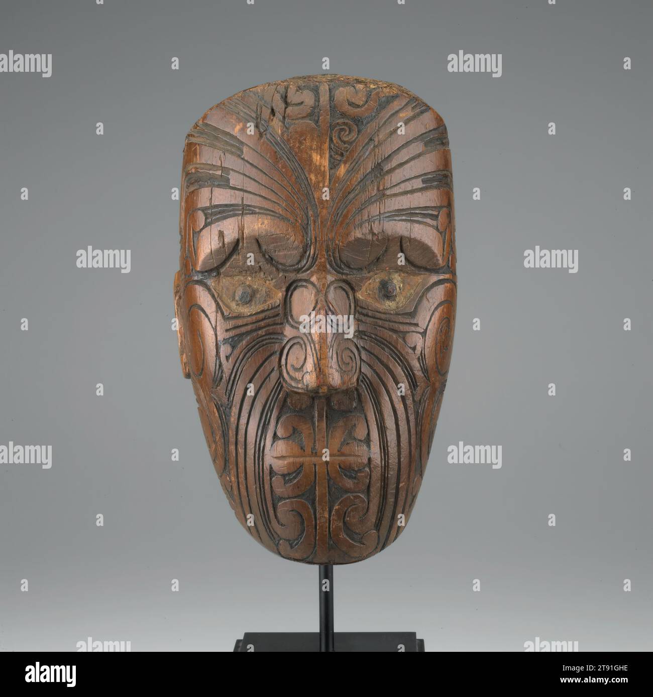 Head, 18th century, 10 9/16 x 6 1/16 x 5 15/16 in. (26.83 x 15.4 x 15.08 cm) (head only), Wood, New Zealand, 18th century, Elaborately carved heads such as this one were mounted on poles and used to mark territorial boundaries. Called rahui, each head served as a warning to trepassers that they were entering the land of another clan. The face is carved into a stern, serious expression, befitting its role as a cautionary signal. It used to have shell inlay in its eyes, which gave them lifelike flash and fire Stock Photo