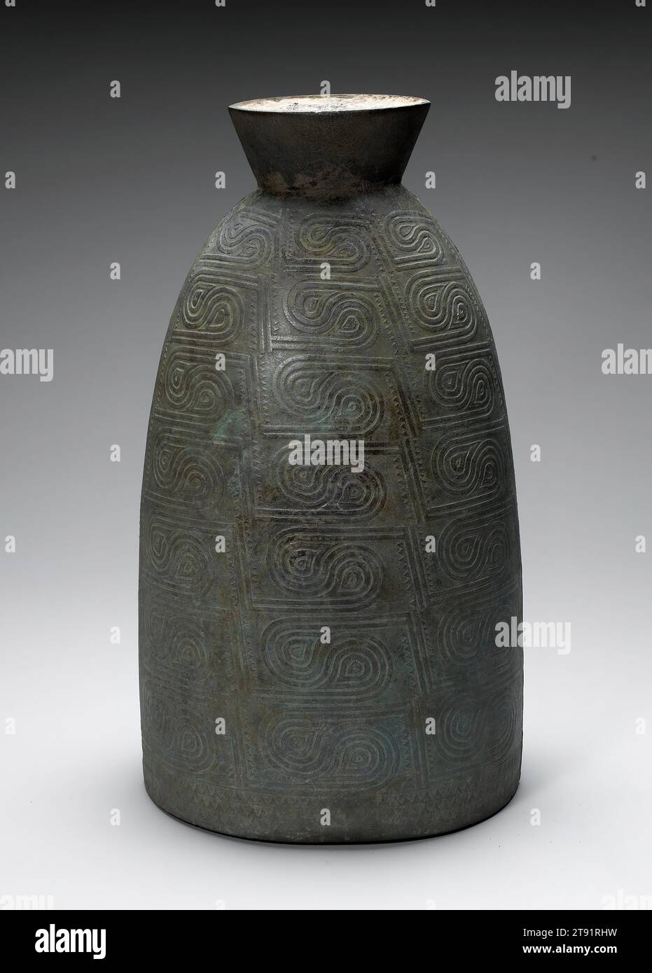 Ceremonial Bell, 3rd-2nd century BCE, 23 5/16 x 12 15/16 x 11 1/4 in. (59.21 x 32.86 x 28.58 cm), Bronze, Vietnam, 3rd-2nd century BCE, The attenuated form, repeated double-spiral decoration, and lines with sawtooth markings are motifs unique to Don Song culture (400 BCE–200 CE), a pan-Southeast Asian civilization inhabiting regions of Vietnam, Cambodia, Thailand, Yunnan province in China, and Indonesia. In the first millennium BCE, Don Song production of magnificent large bronzes increased. This bell was cast using the piece-mold process developed by neighboring Chinese bronze-founders Stock Photo