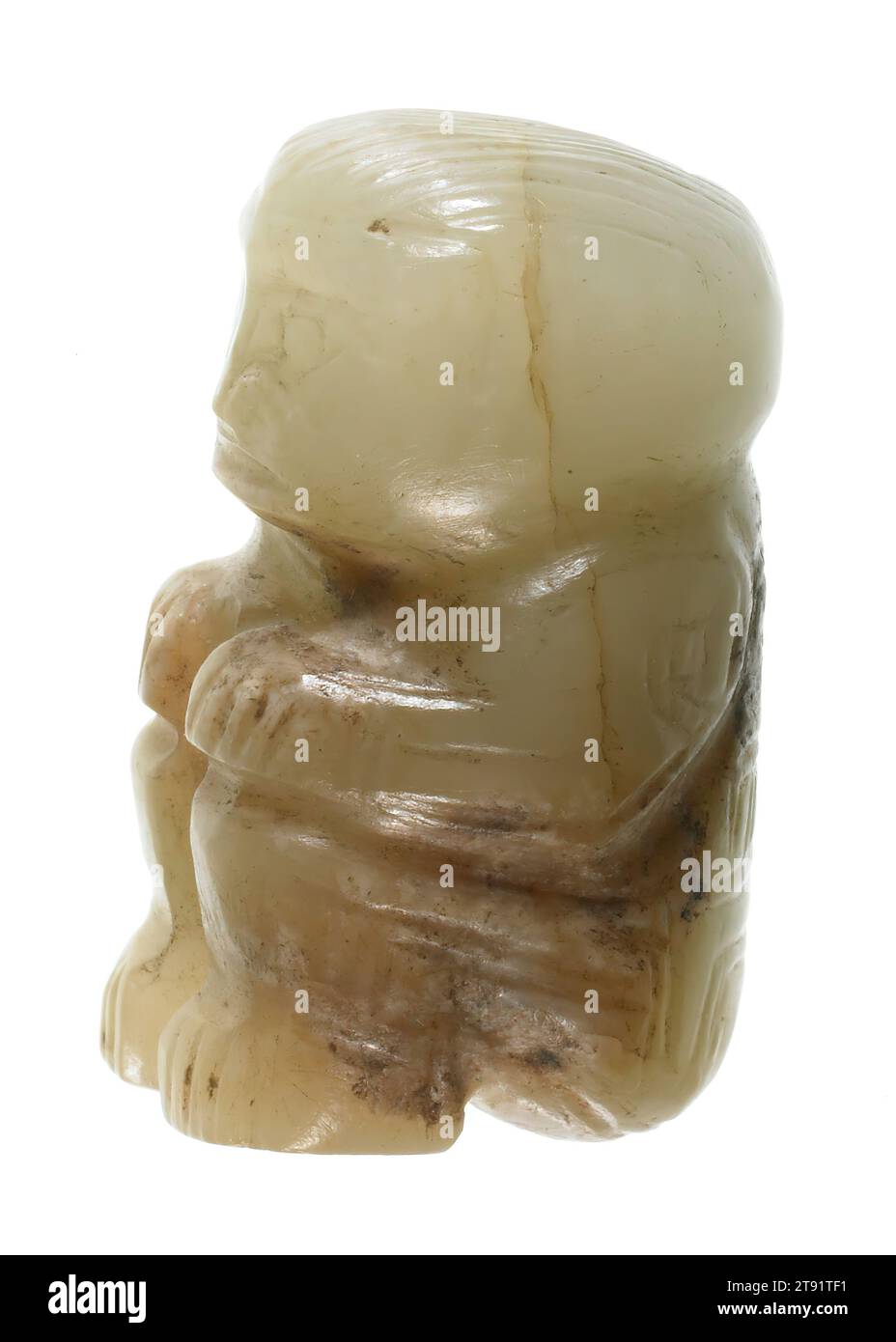 Seated Figurine Pendant, 1122-722 BCE, H.1 x W.1/2 x D.5/8 in., Translucent white jade with opaque calcification, China, 12th-8th century BCE Stock Photo