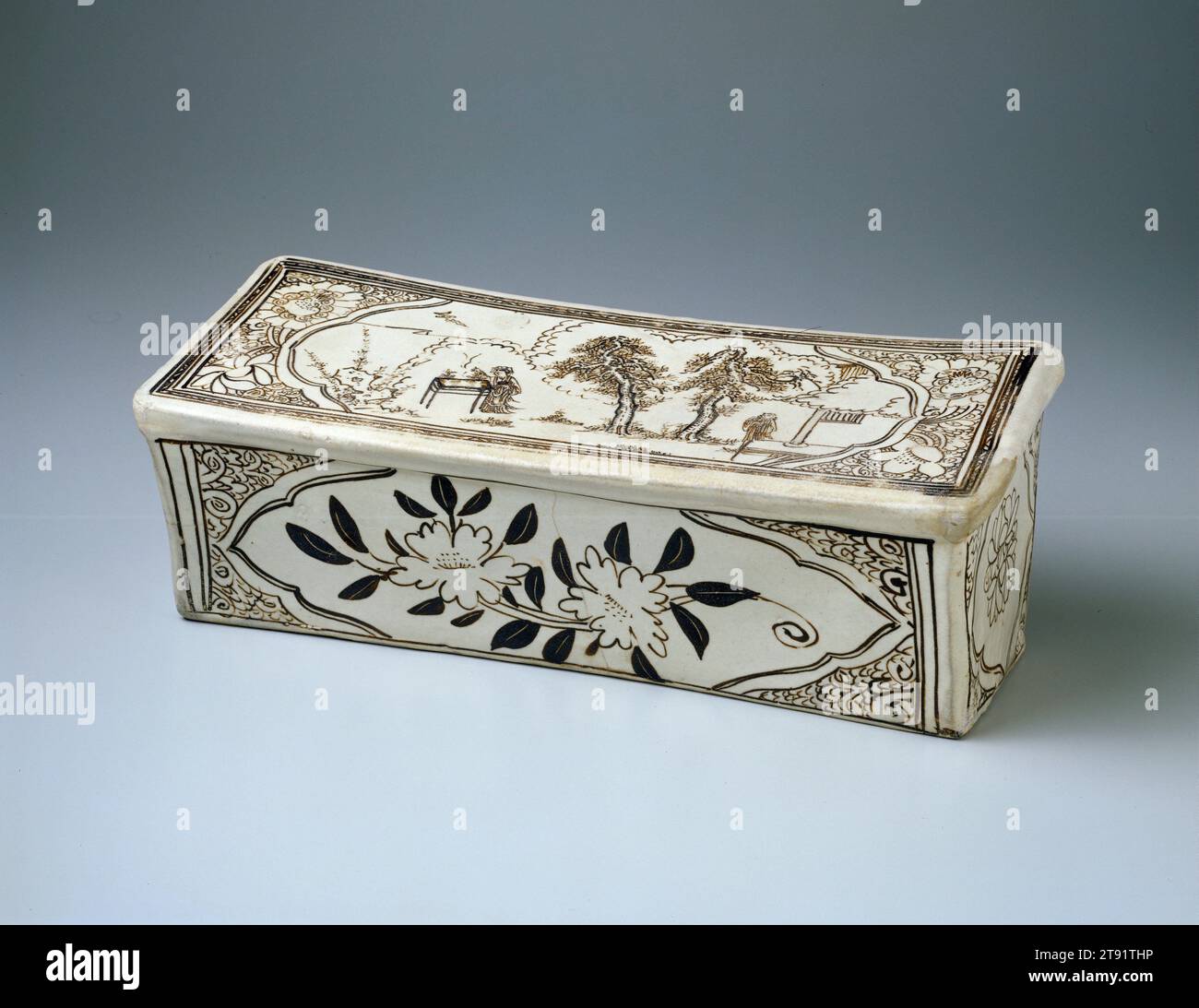 Rectangular Pillow, late 13th-early 14th century, Wang Family Workshop, 6 1/8 x 16 1/4 x 6 3/4 in. (15.56 x 41.28 x 17.15 cm), Tz'u-chou ware Stoneware with iron-brown painted décor on a white slip under transparent glaze, China, 13th-14th century, The Daoist scene depicted on this headrest suggests a ritual performed in honor of Chang'e, the Goddess of the Moon. A well-attired woman is burning incense at a table in a garden. Two tall pines, a tai hu garden rock, bamboo, and a pavilion complete the scene. The front panel encloses a camellia branch with two blossoms Stock Photo