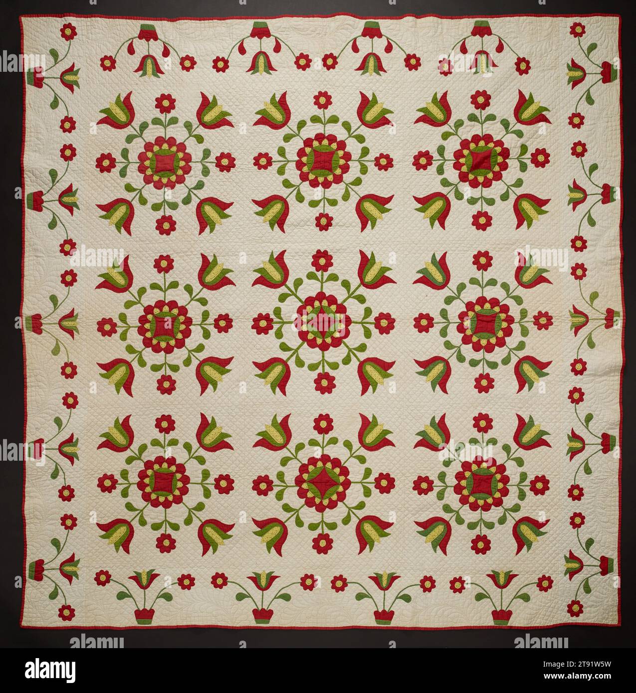 Floral appliqué quilt, c. 1860s–70s, 90 1/8 x 86 1/2 in. (228.92 x 219.71 cm), Cotton; pieced, appliquéd, and quilted, United States, 19th century, Many quilts from the 1700s and early 1800s featured a large central motif, called a medallion. But in the mid-1800s, block-style quilts surged in popularity. This one has nine blocks, each punctuated with a spray of green and red tulips. One advantage of such quilts was that the squares—usually one or two feet wide—were easy to carry along on social visits, allowing women to stitch as they chatted. This meant 'free time' was always productive. Stock Photo