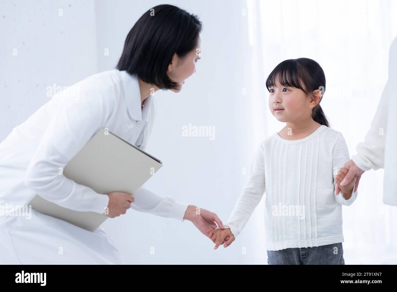 Female nurse talking to a girl patient Stock Photo - Alamy