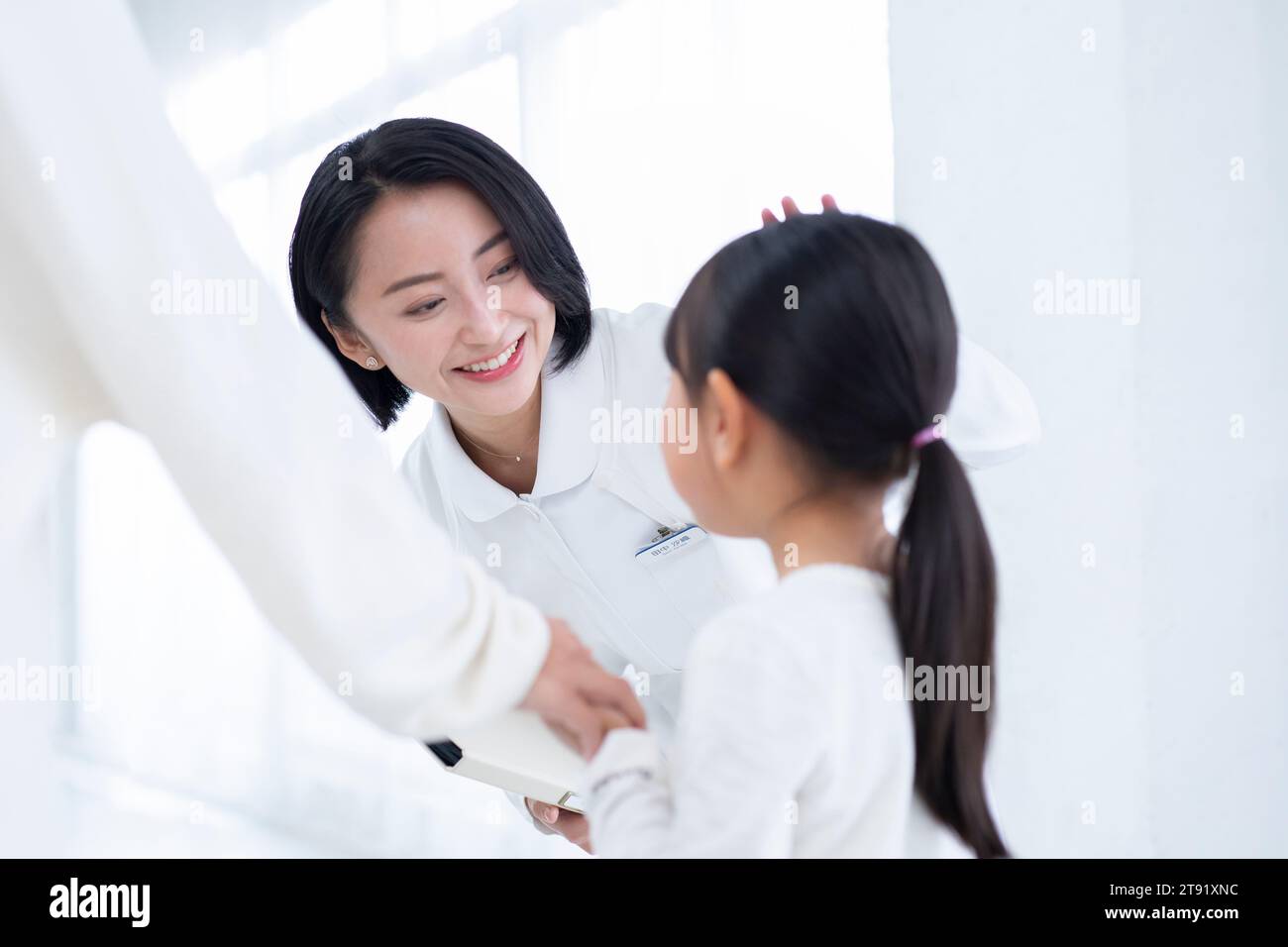 Female nurse talking to a girl patient Stock Photo - Alamy