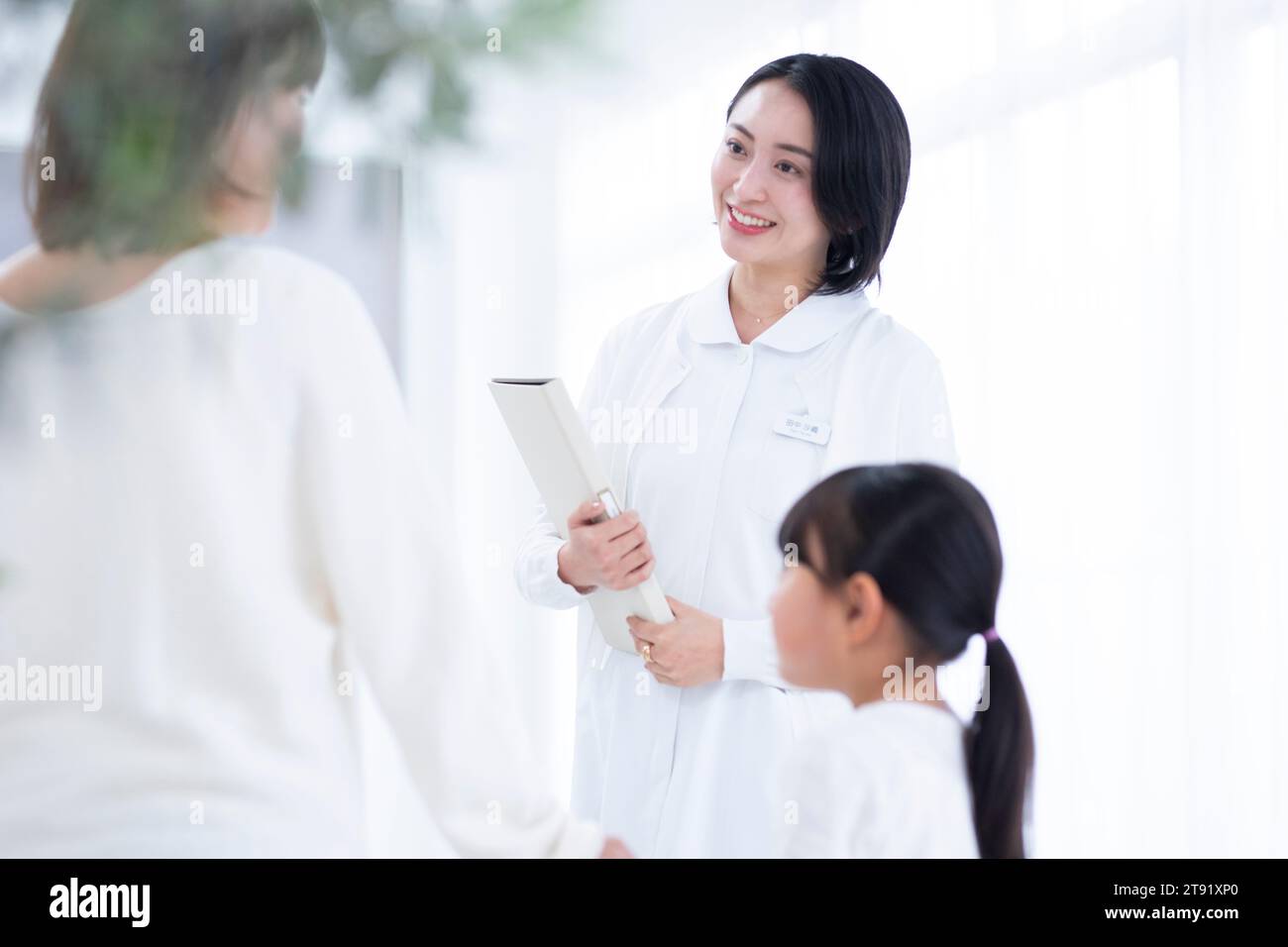 Female nurse talking to a girl patient Stock Photo - Alamy