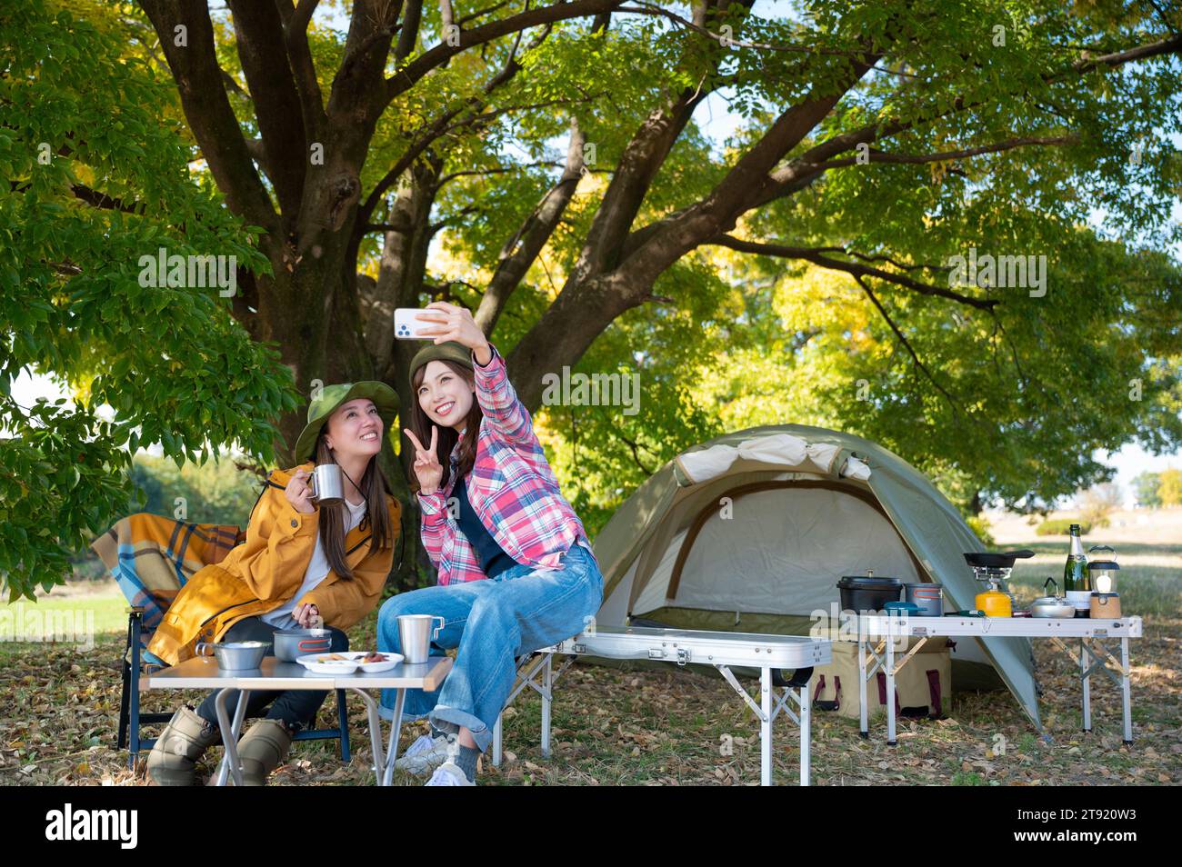 Two women enjoying camping Stock Photo
