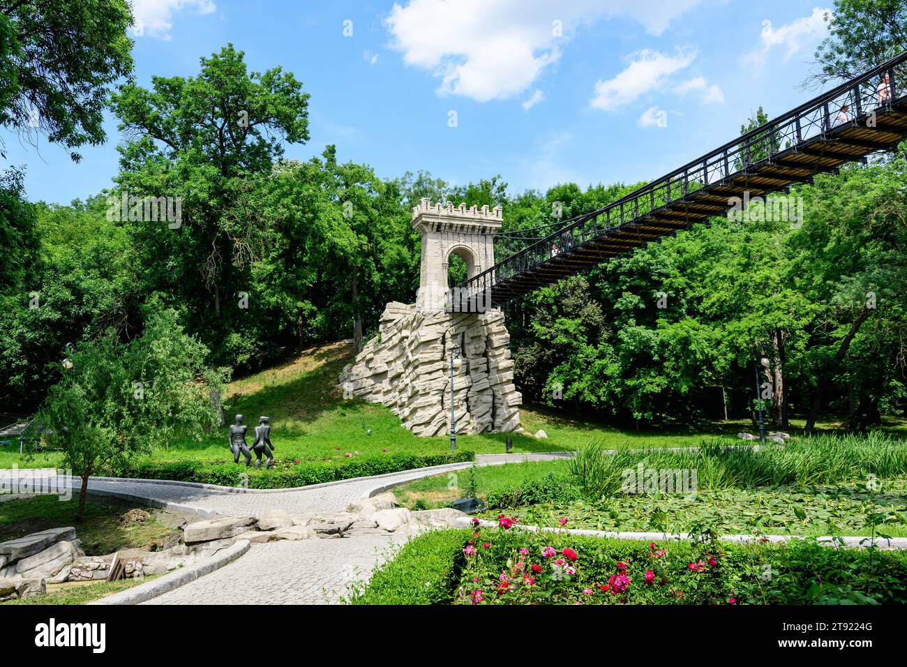 Renovated suspended metallic bridge in Nicolae Romaescu park from Craiova in Dolj county, Romania, in a beautiful sunny spring day Stock Photo