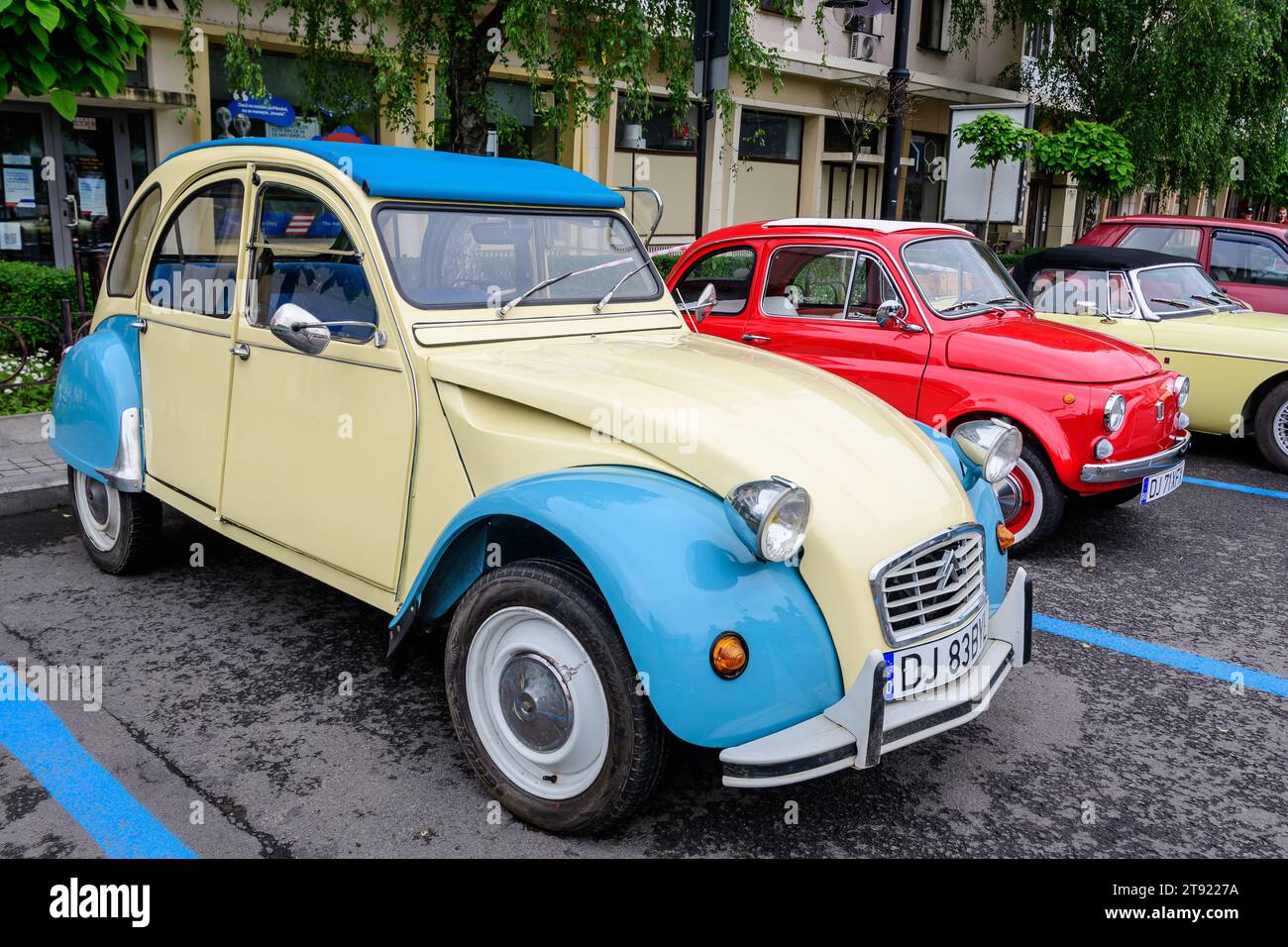 Craiova, Romania, 29 May 2022: One vivid yellow and blue Citroen French vintage car parked in a street at an event for vintage cars collections, in a Stock Photo