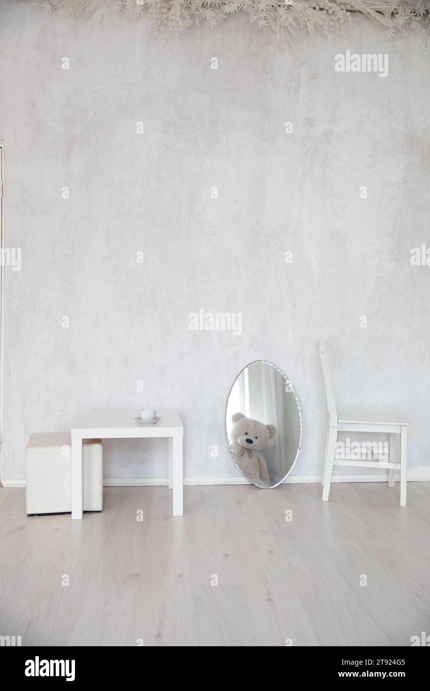 Interior of a white room without people with a chair and a mirror Stock Photo