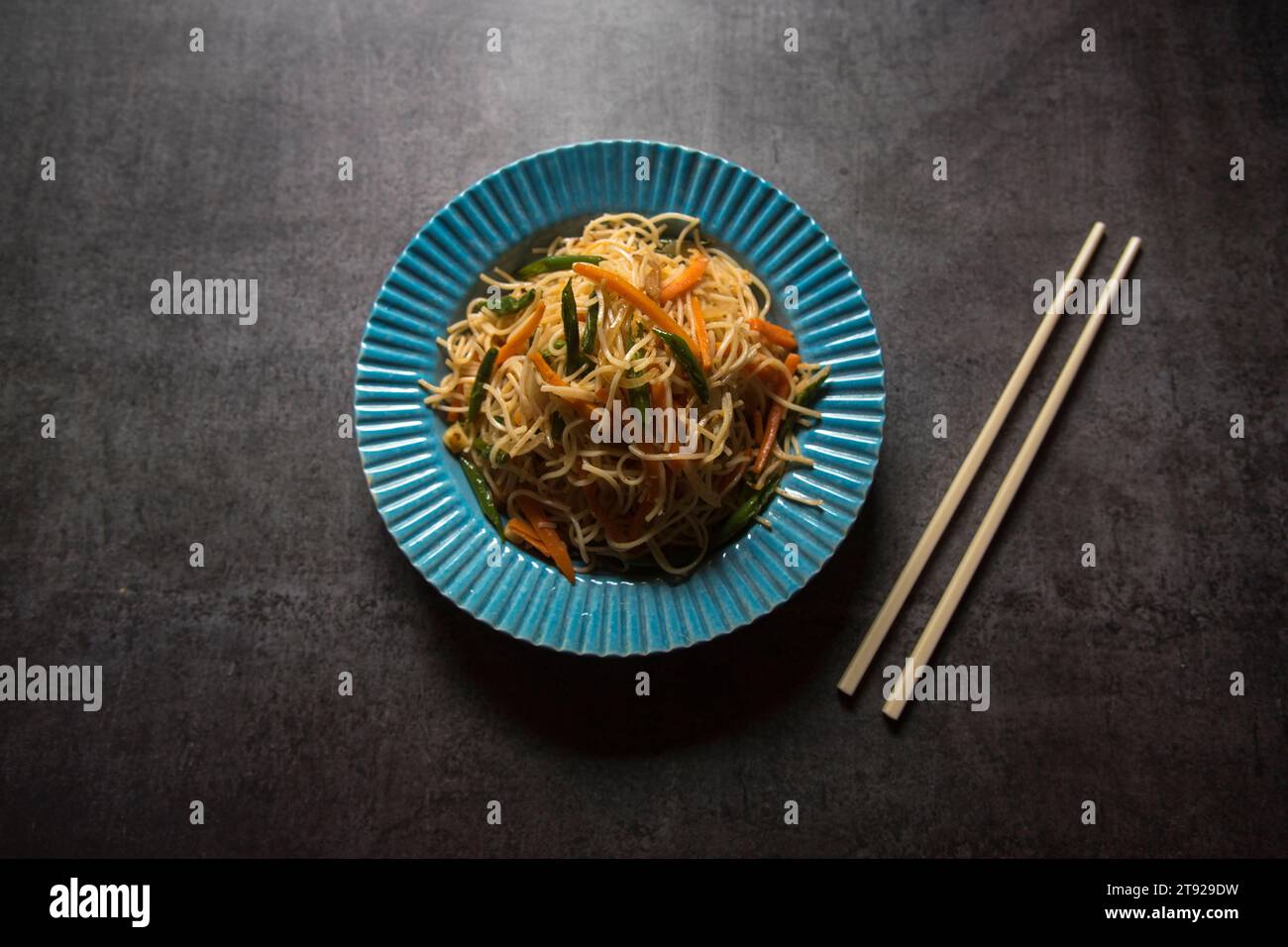 Schezwan noodles or vegetable hakka chowmein served in a bowl. Close up, selective focus. Stock Photo