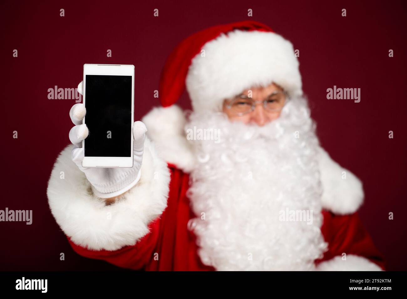 Beautiful happy Santa Claus is showing the white blank screen of a ...