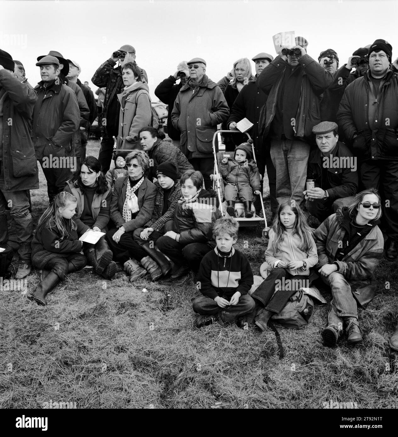 Hare Coursing. Spectators, family groups gather for a days coursing at the Waterloo Cup. They are watching the hare being chased on the 'running field'. Near Altcar, Lancashire, England 2002 2000s HOMER SYKES Stock Photo