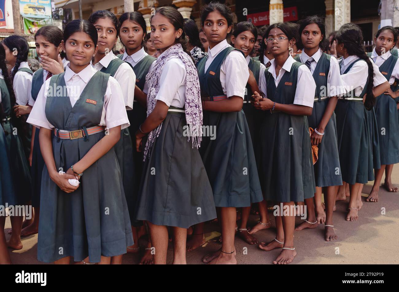 South Indian school girls in uniform dress orderly queuing up to visit