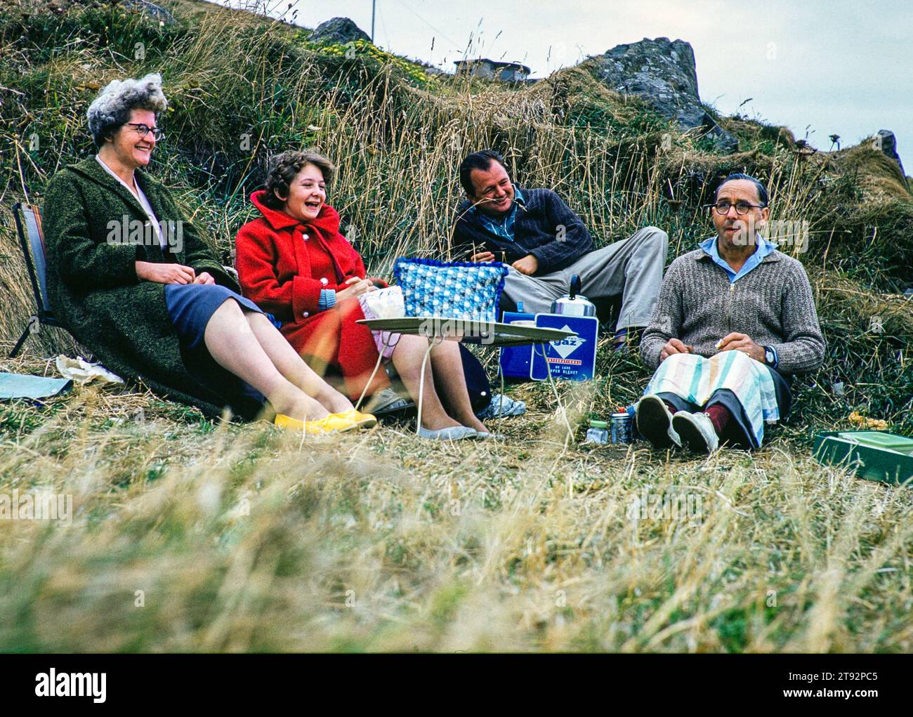 Family picnic with Mum dad and daughter, wearing warm clothes in British summer, England, UK 1961 Stock Photo