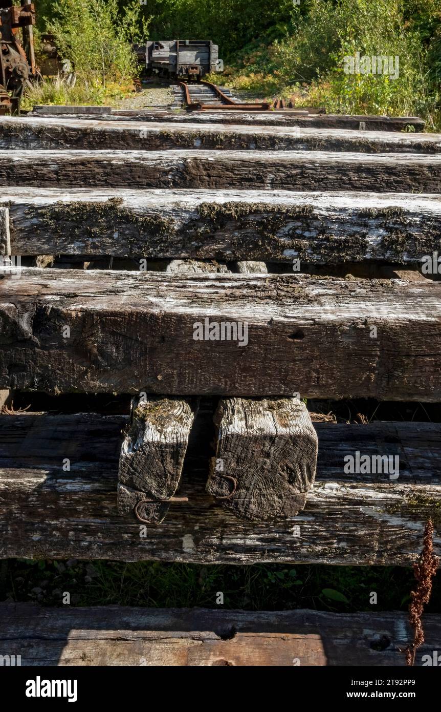 Stack stacked pile of old weathered wooden timber rail railway railroad track sleepers England UK United Kingdom GB Great Britain Stock Photo