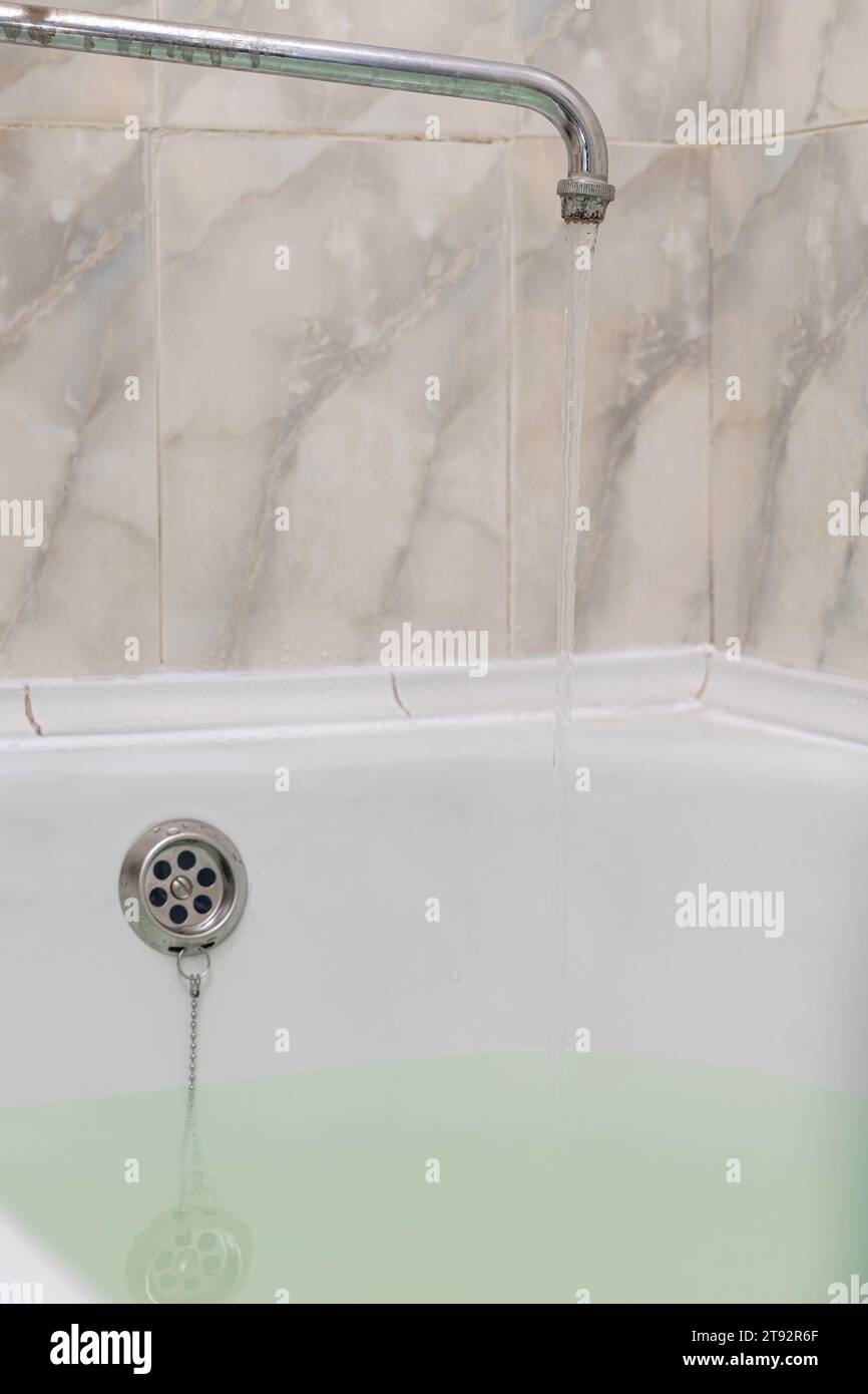 water flows from the tap filling the bath. filling the bathtub with