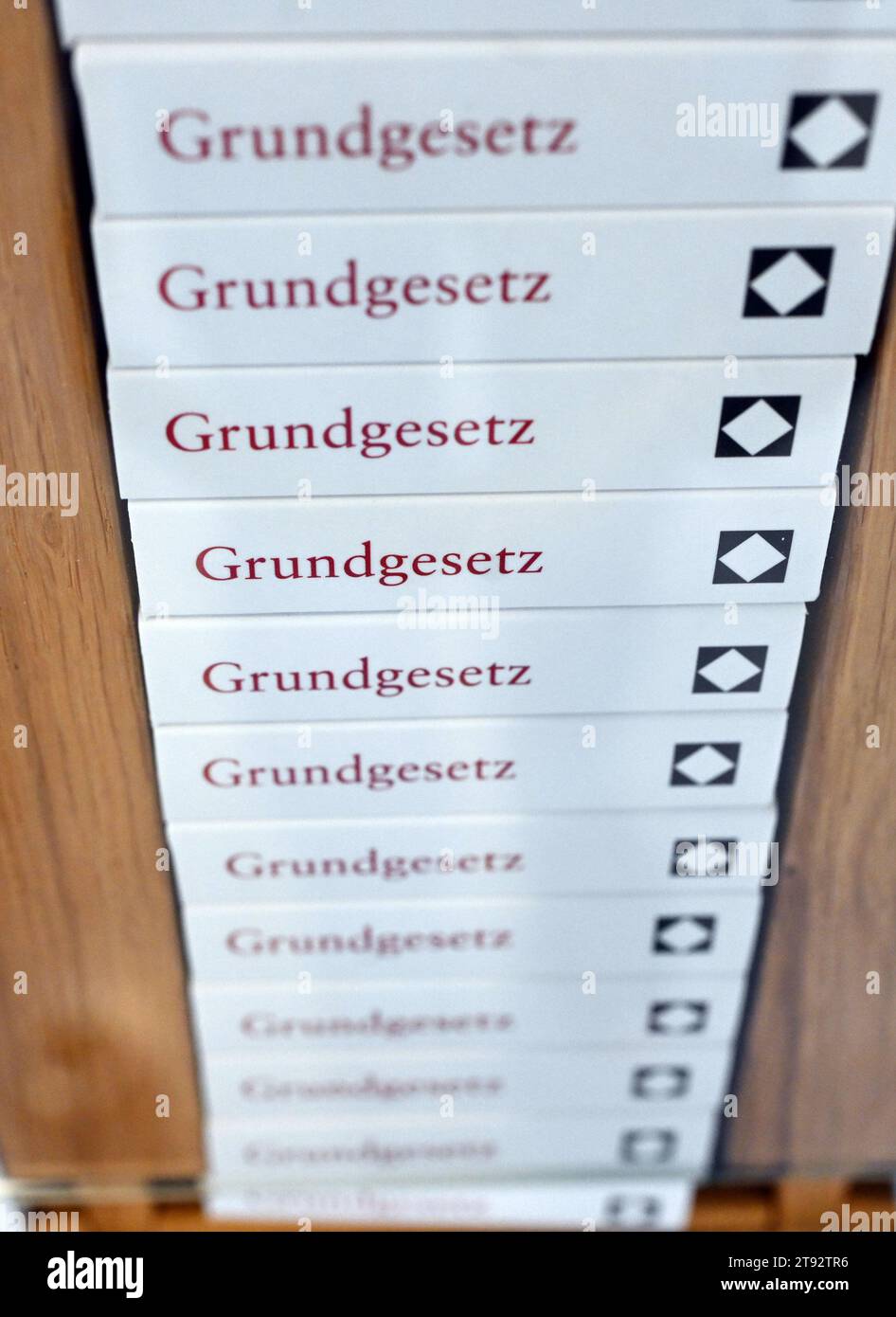 Karlsruhe, Germany. 22nd Nov, 2023. Miniature copies of the Basic Law are on display in the foyer of the Federal Constitutional Court. The First Senate of the court announced its ruling on report notes for dyslexics. According to the ruling, comments in the school leaving certificate about the non-assessment of individual achievements are generally required. Credit: Uli Deck/dpa/Alamy Live News Stock Photo