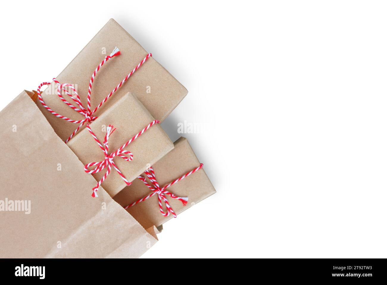 Christmas gift boxes wrapped in craft paper with striped red and white ...