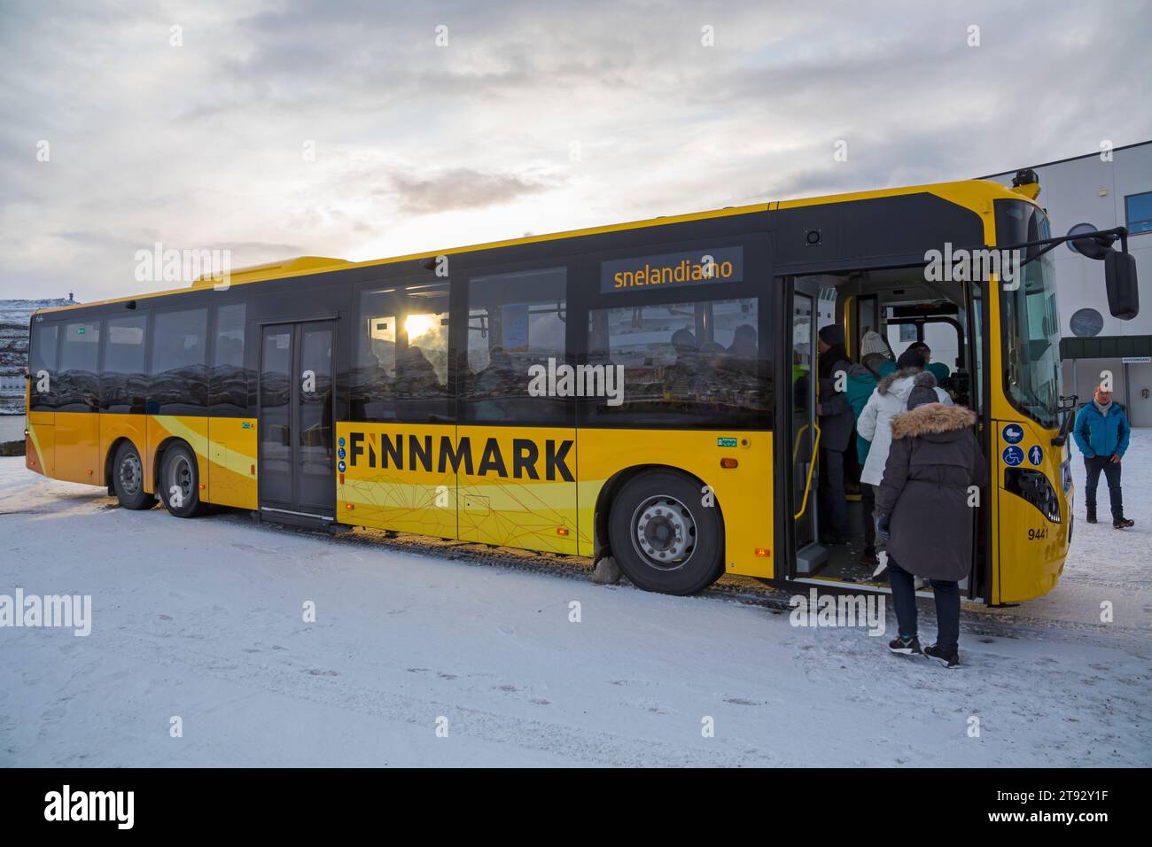 Passengers boarding yellow Snelandia bus at Hammerfest, Norway, Scandinavia, Europe in October Stock Photo