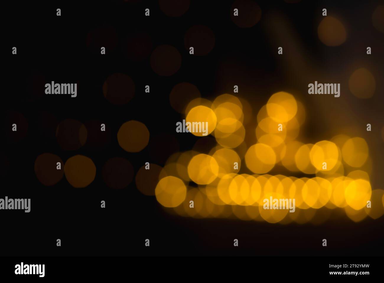 Immerse your designs in the festive glow of this bokeh, captured with a 75mm lens featuring nine-sided nonagons in rich gold on the right and subtly g Stock Photo