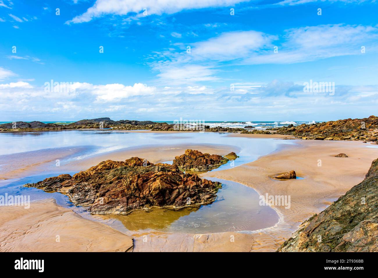 Rocky beach where sand, stones and sea mix in Serra Grande on the south coast of the state of Bahia Stock Photo
