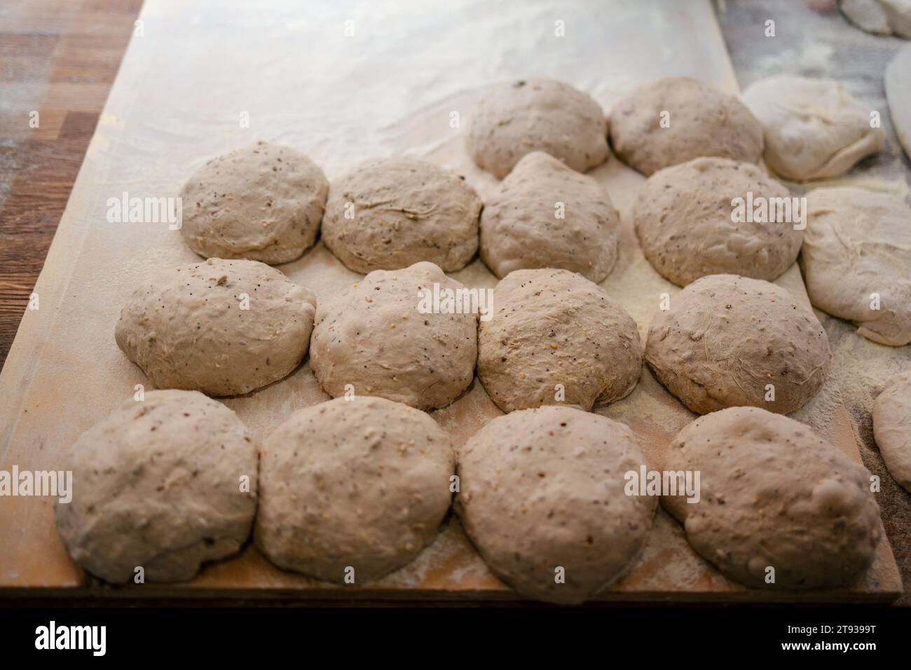 Portrait of several loaf-shaped bread doughs on a table in a bakery ready to bake in the oven Stock Photo