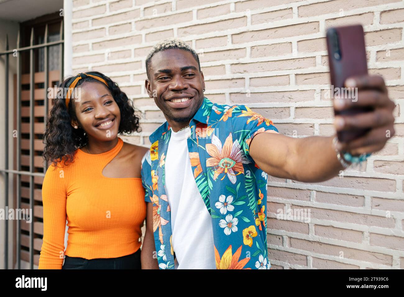 Young black couple wearing casual and colorful clothes taking a selfie ...