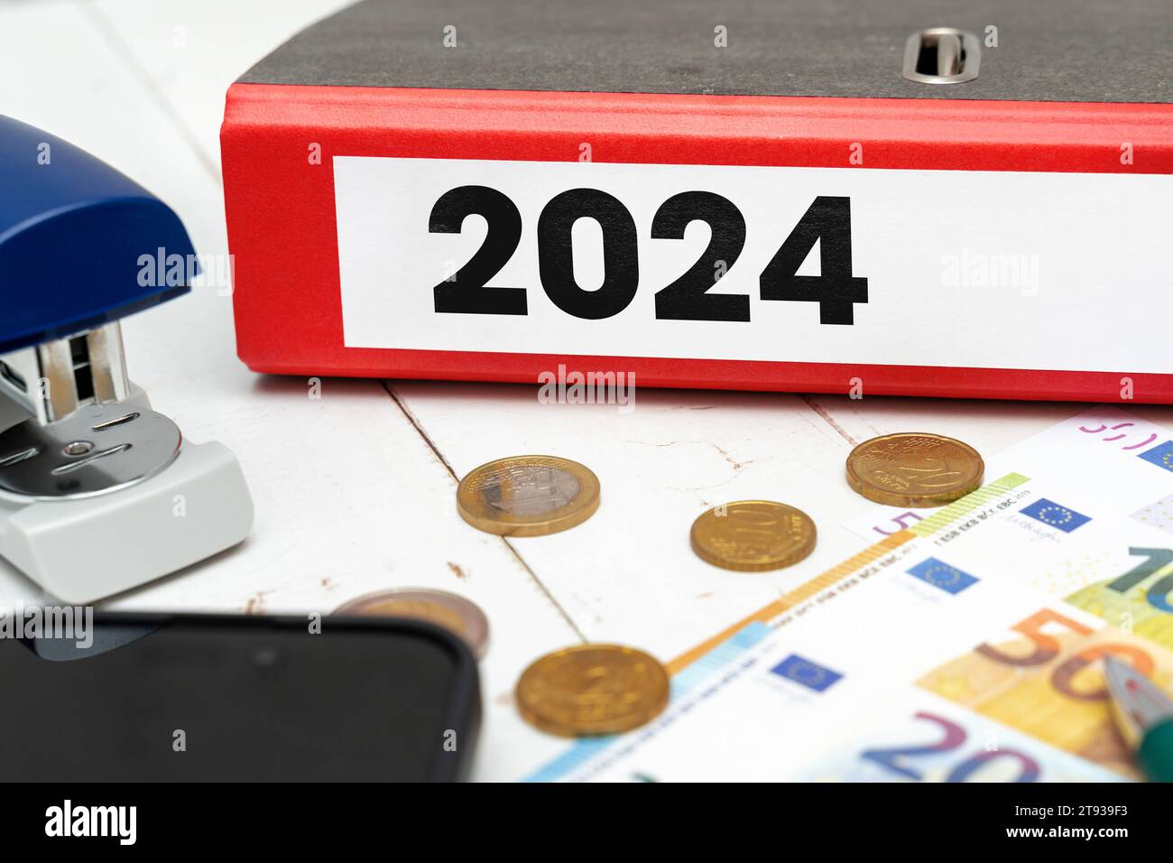 22 November 2023: red folder in an office next to euro banknotes with 