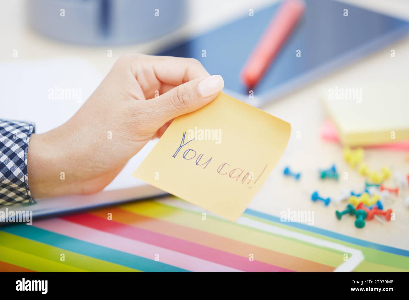 Human hand holding adhesive note with You can text Stock Photo