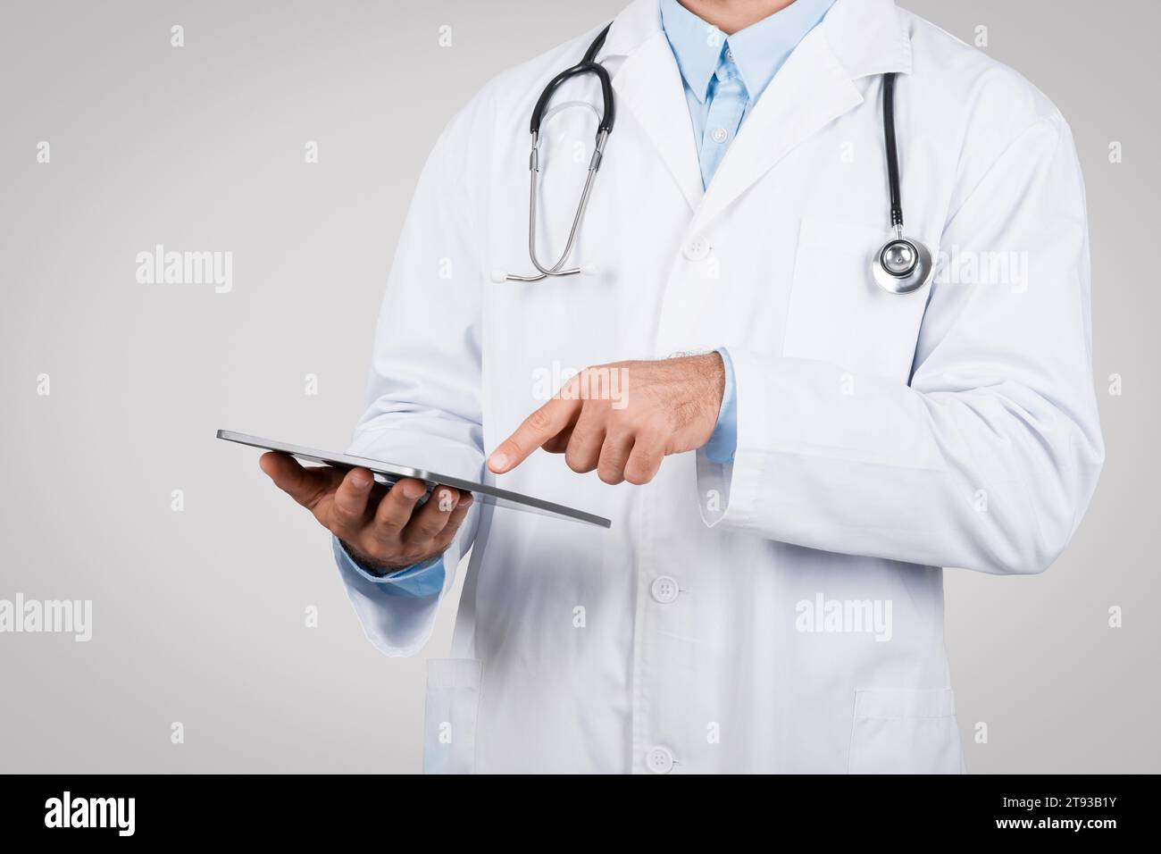 Doctor man using digital tablet, close-up view Stock Photo