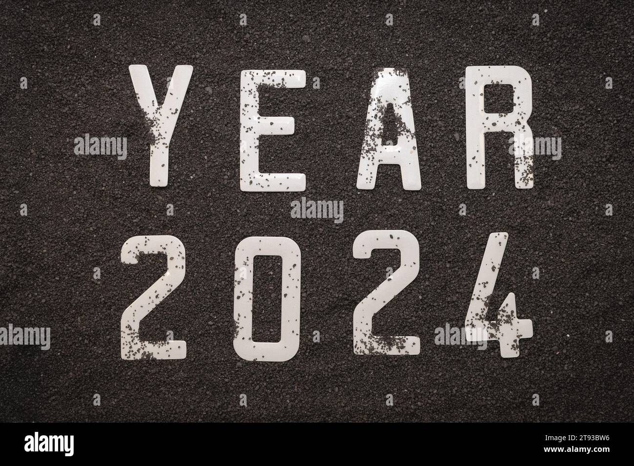 Happy New Year 2024 New Year 2024 concept on the black sand of a beach