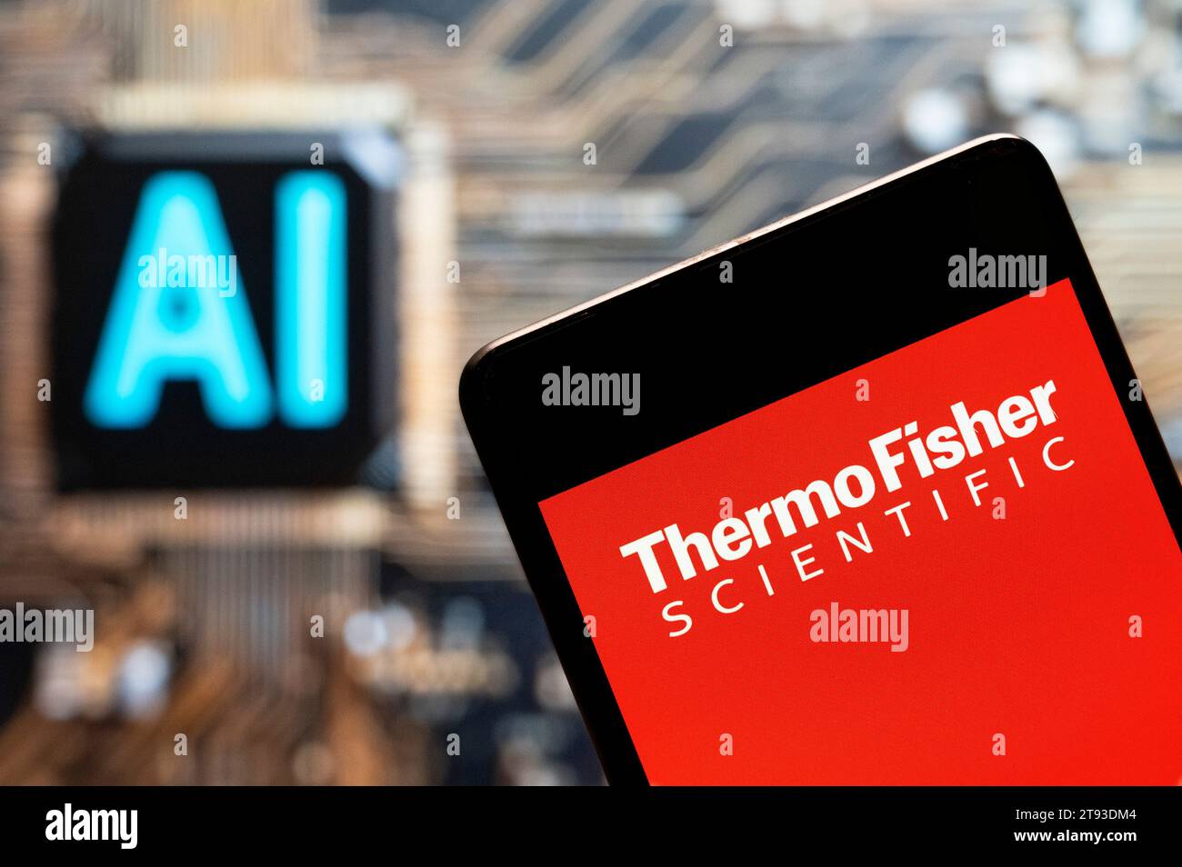 In this photo illustration, the American supplier of scientific instrumentation, reagents and consumables, and software services company, Thermo Fisher Scientific (NYSE: TMO) logo seen displayed on a smartphone with an Artificial intelligence (AI) chip and symbol in the background. (Photo by Budrul Chukrut / SOPA Images/Sipa USA) *** Strictly for editorial news purposes only *** Stock Photo