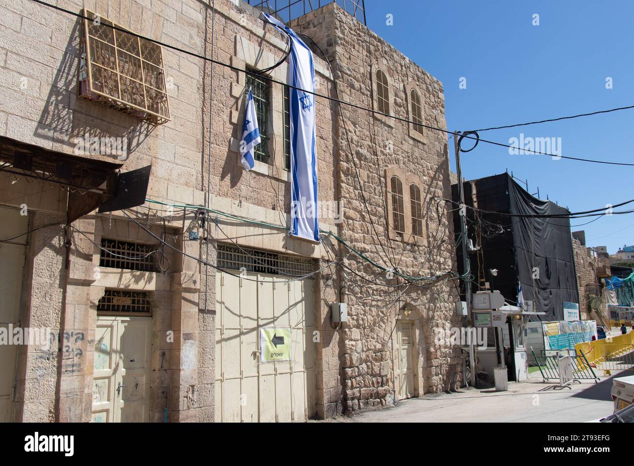 Jewish house in the Muslim district of Hebron city. Flag of Israel on the house. Ancient city of Halil. 21 April 2022 Stock Photo