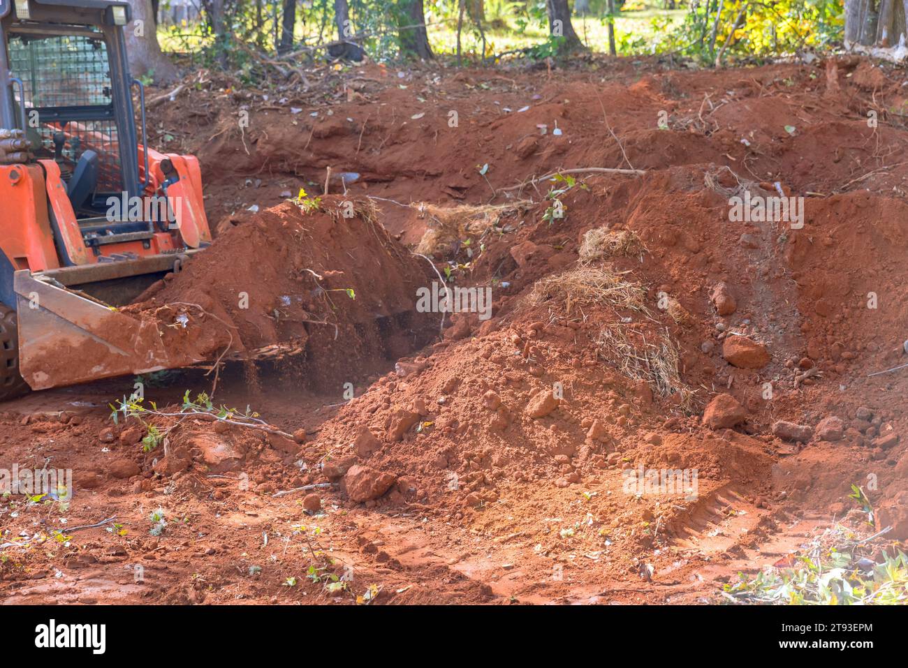 On construction site tractor is leveling ground for house residential