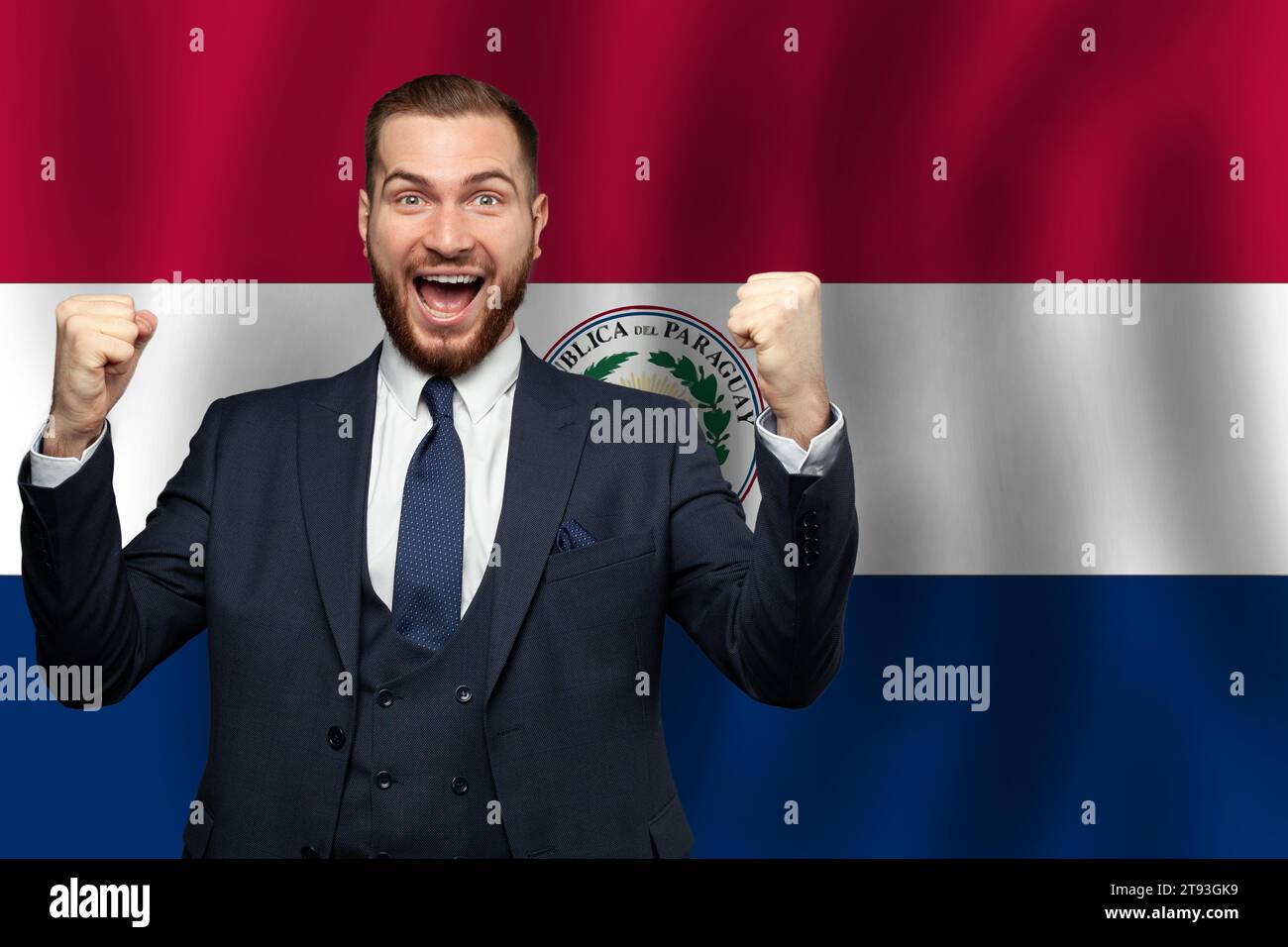 Paraguayan happy businessman on the background of flag of Paraguay Business, education, degree and citizenship concept Stock Photo