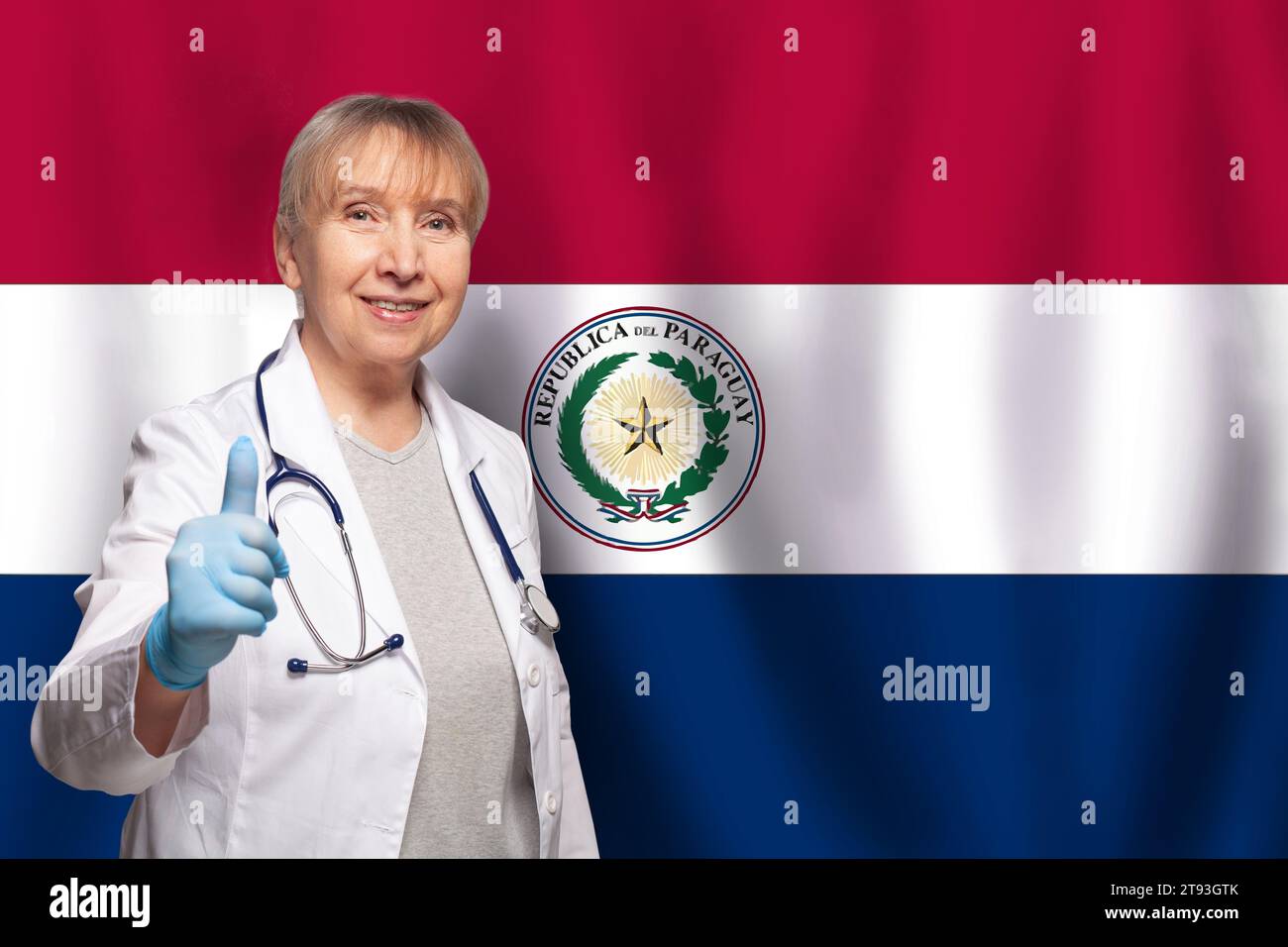 Paraguayan smiling mature doctor woman holding stethoscope on flag of Paraguay background Stock Photo